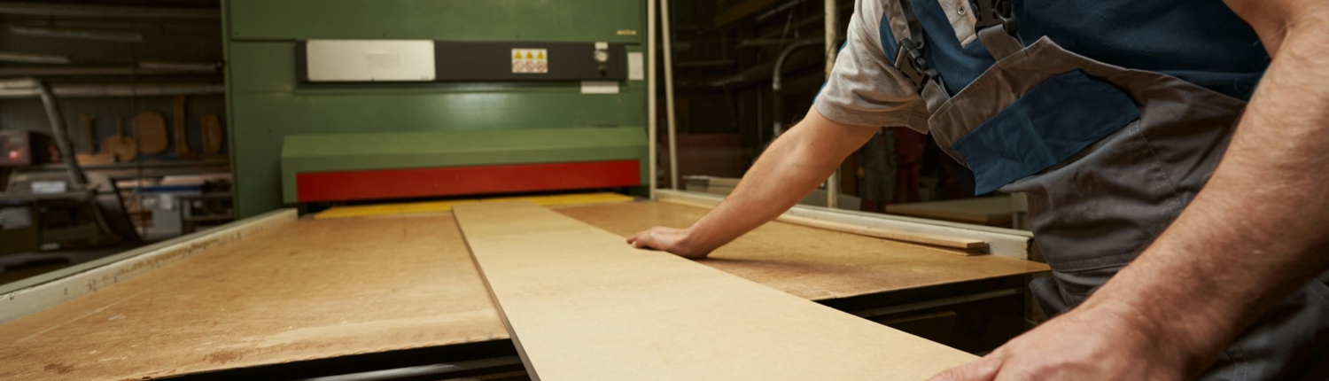 Attentive male person working at woodworking manufacture