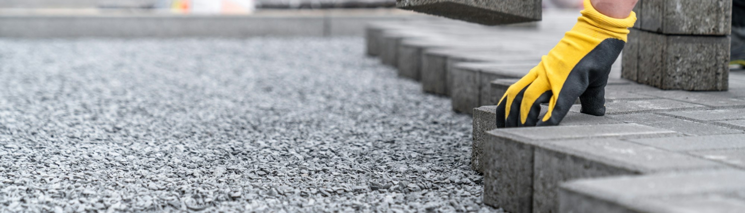 laying interlocking pavers during the construction of sidewalks and roads. copy space
