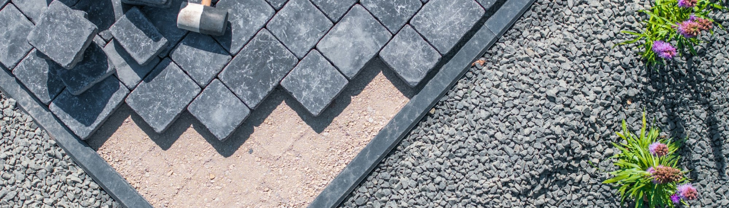 Laying Paving Stones in a Garden Pathway on a Sunny Day