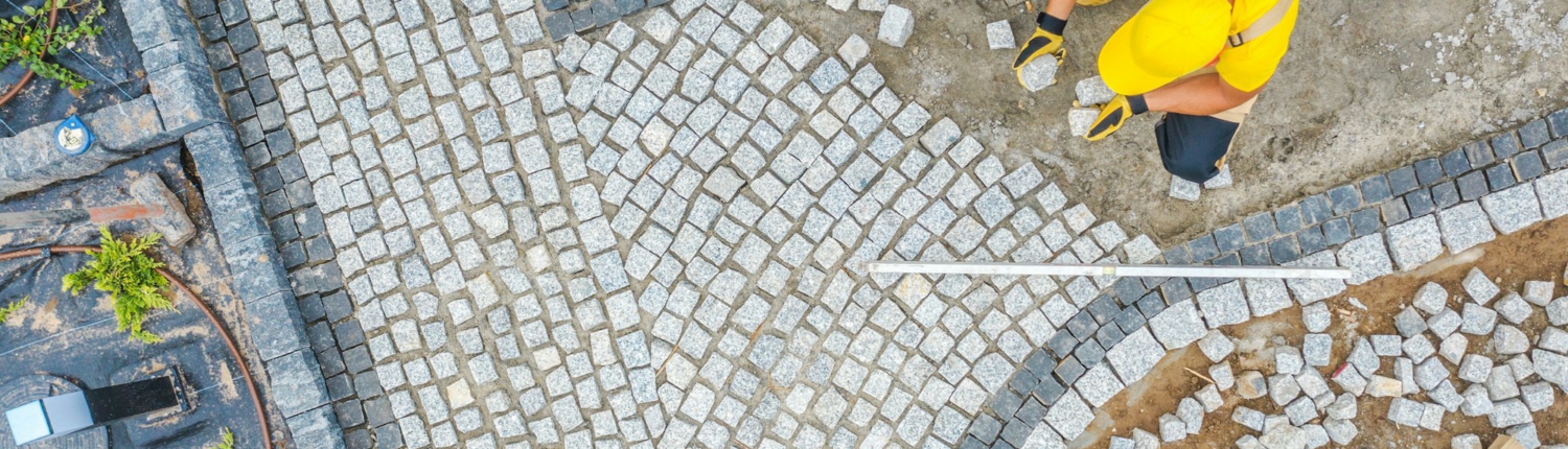 Worker Paving Garden Path Aerial Vista